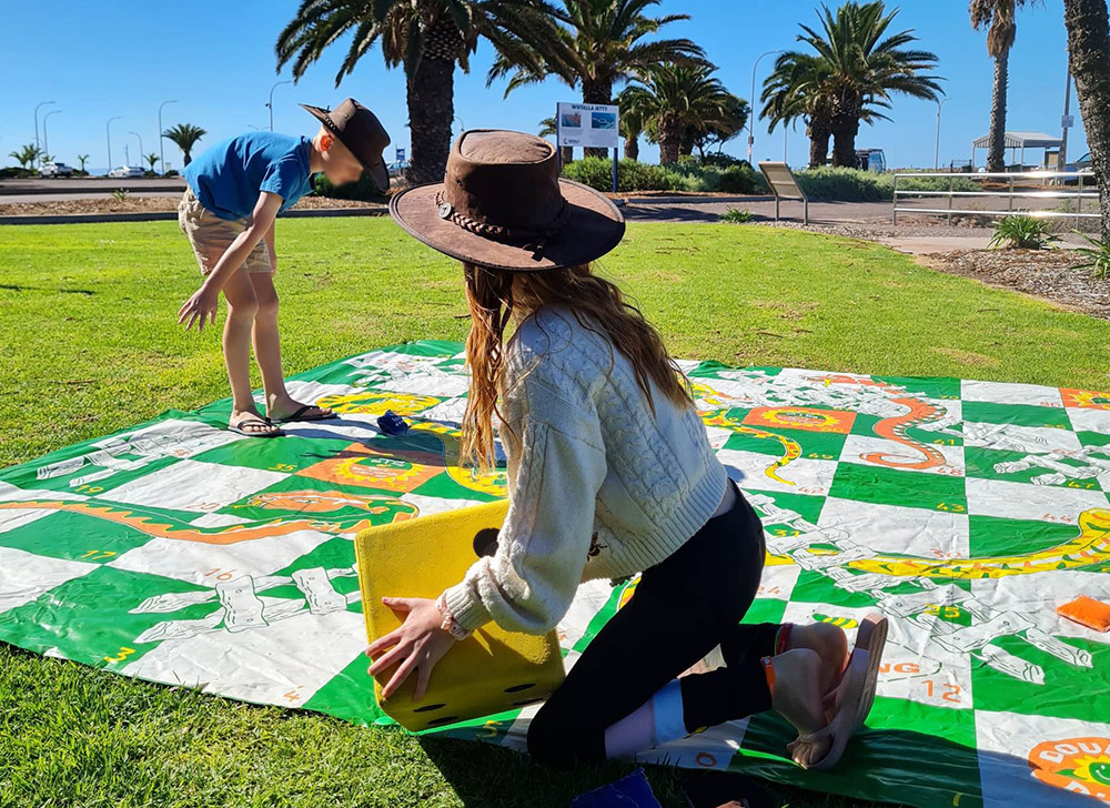 Photo: Kids playing on giant snakes and ladders board in park